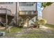 Backyard view of the townhome featuring a wooden deck and concrete patio area at 117 Gallent Hedge Trl, Apex, NC 27539