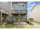 Townhome backyard featuring a wooden deck and a concrete patio at 117 Gallent Hedge Trl, Apex, NC 27539