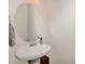 Bathroom with a pedestal sink, decorative round mirror and a towel rack at 117 Gallent Hedge Trl, Apex, NC 27539
