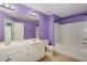 Bathroom with double sinks, a large mirror, and a combined tub and shower at 117 Gallent Hedge Trl, Apex, NC 27539