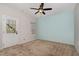 Bedroom with a ceiling fan, blue accent wall, and door to the outside at 117 Gallent Hedge Trl, Apex, NC 27539