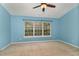 Bright blue bedroom with a large window offering a view of the outdoors at 117 Gallent Hedge Trl, Apex, NC 27539