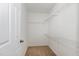 Walk-in closet with wire shelving for ample storage, freshly painted in white at 117 Gallent Hedge Trl, Apex, NC 27539