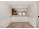 Dining area featuring wainscoting and a pass-through to the kitchen at 117 Gallent Hedge Trl, Apex, NC 27539