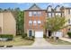 Charming two-story brick townhome features a garage and a blue front door at 117 Gallent Hedge Trl, Apex, NC 27539