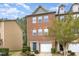Charming two-story brick townhome features a garage and a blue front door at 117 Gallent Hedge Trl, Apex, NC 27539
