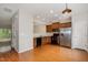 Traditional kitchen with hardwood floors, stainless steel refrigerator, and wood cabinetry at 117 Gallent Hedge Trl, Apex, NC 27539
