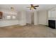 Cozy living room with fireplace, neutral carpet, and partial view into the kitchen at 117 Gallent Hedge Trl, Apex, NC 27539
