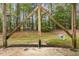 View from the covered patio highlighting the support beams and treeline at 117 Gallent Hedge Trl, Apex, NC 27539