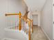 Carpeted staircase with wood railing leads to the upper level of the home at 117 Gallent Hedge Trl, Apex, NC 27539