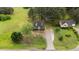 Aerial view of a home nestled on a spacious lot with mature trees and a long driveway at 120 Stillmeadow Dr, Louisburg, NC 27549
