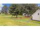 Large fenced yard featuring a storage shed and fire pit area at 120 Stillmeadow Dr, Louisburg, NC 27549