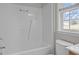 Bathroom featuring a shower-tub combo and a window at 120 Stillmeadow Dr, Louisburg, NC 27549