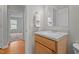A partial view of a bathroom with wood vanity and an open door at 120 Stillmeadow Dr, Louisburg, NC 27549