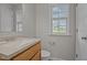 Well-lit bathroom featuring a wood vanity and neutral color scheme at 120 Stillmeadow Dr, Louisburg, NC 27549