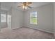 Bedroom with neutral walls, carpet, and two bright windows at 120 Stillmeadow Dr, Louisburg, NC 27549