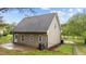 Exterior view of a home featuring vinyl siding, a fenced yard, and a back patio area at 120 Stillmeadow Dr, Louisburg, NC 27549