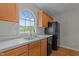 Kitchen with stainless steel sink, black appliances, and wood cabinets at 120 Stillmeadow Dr, Louisburg, NC 27549
