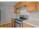 Kitchen with stainless steel oven and wood cabinets at 120 Stillmeadow Dr, Louisburg, NC 27549
