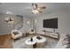 Bright living room with wood floors, neutral paint, and ceiling fan at 120 Stillmeadow Dr, Louisburg, NC 27549