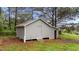 Outbuilding or shed showing neutral siding, steps to entry, and additional storage space at 120 Stillmeadow Dr, Louisburg, NC 27549