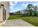 Backyard with a concrete patio and lush green grass, perfect for outdoor enjoyment at 121 Pisgah St, Sanford, NC 27330