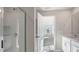 Modern bathroom with glass shower enclosure, updated vanity, and doorway to the bedroom at 121 Pisgah St, Sanford, NC 27330