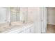 Bathroom featuring double sinks, quartz counters, framed mirror, and a shower with glass enclosure at 121 Pisgah St, Sanford, NC 27330