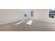 A bright and airy bedroom with plush carpet and three windows for ample natural light at 121 Pisgah St, Sanford, NC 27330