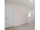 This bedroom has neutral walls, carpet, and two doors with white trim at 121 Pisgah St, Sanford, NC 27330