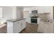 Modern kitchen featuring stainless steel appliances and gray granite countertops at 121 Pisgah St, Sanford, NC 27330