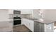 Bright kitchen featuring stainless steel appliances, gray backsplash and granite countertops at 121 Pisgah St, Sanford, NC 27330