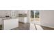 Kitchen with white cabinets, granite counters, stainless appliances, and sliding door access to outdoors at 121 Pisgah St, Sanford, NC 27330
