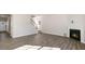 Open concept living room featuring modern floors, fireplace, and staircase at 121 Pisgah St, Sanford, NC 27330