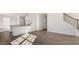 An open-concept living room with wood floors, staircase, and views of the kitchen at 121 Pisgah St, Sanford, NC 27330