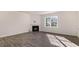 Open living room featuring modern floors, fireplace, and a large window at 121 Pisgah St, Sanford, NC 27330