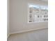 Bright bedroom with a large window overlooking neighborhood and plush carpeting, creating an airy and comfortable atmosphere at 124 Pisgah St, Sanford, NC 27330