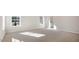 Bedroom with carpet and two windows to the outside providing natural light to the room at 124 Pisgah St, Sanford, NC 27330