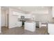 Open kitchen featuring white cabinets, granite countertops, stainless appliances, and an island, making meal prep a joy at 124 Pisgah St, Sanford, NC 27330
