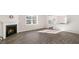 Open floorplan featuring wood-look floors, a fireplace, and a view of the kitchen at 124 Pisgah St, Sanford, NC 27330
