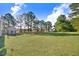 Large grassy backyard featuring a privacy fence and ample space for activities at 13 Parkers Pointe Dr, Benson, NC 27504