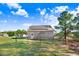 Spacious backyard with a fenced perimeter, green grass, and solar panels on the roof at 13 Parkers Pointe Dr, Benson, NC 27504