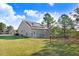 Backyard view of a home equipped with solar panels and a storage building at 13 Parkers Pointe Dr, Benson, NC 27504