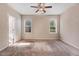 Bedroom with neutral carpet, ceiling fan, and windows providing natural light at 13 Parkers Pointe Dr, Benson, NC 27504