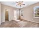Bedroom with neutral carpet, ceiling fan, and plenty of natural light from multiple windows at 13 Parkers Pointe Dr, Benson, NC 27504