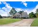 Inviting home with a well-maintained lawn, attractive landscaping, and long driveway at 13 Parkers Pointe Dr, Benson, NC 27504