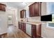 Kitchen features stainless steel dishwasher, sink, granite counters, and dark hardwood floors at 13 Parkers Pointe Dr, Benson, NC 27504