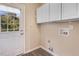 Bright laundry room with built-in cabinets, a door to the exterior, and plenty of outlets at 13 Parkers Pointe Dr, Benson, NC 27504