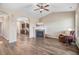 Cozy living room with fireplace, ceiling fan, and stylish wood flooring at 13 Parkers Pointe Dr, Benson, NC 27504