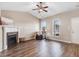Bright living room boasts vaulted ceilings, a ceiling fan, fireplace, and hardwood floors at 13 Parkers Pointe Dr, Benson, NC 27504